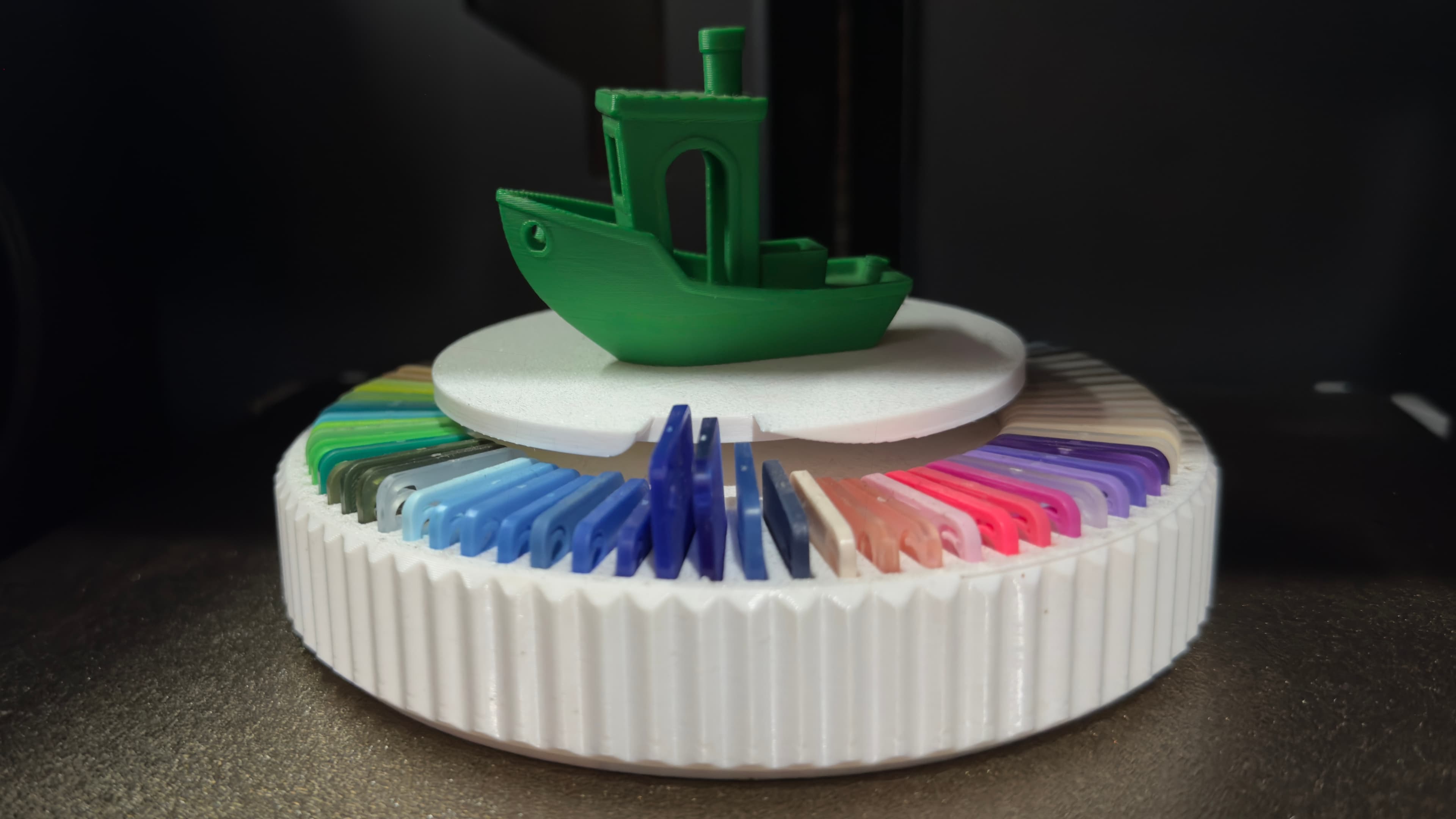 3D printer mid-print with a Benchy calibration model on the build plate