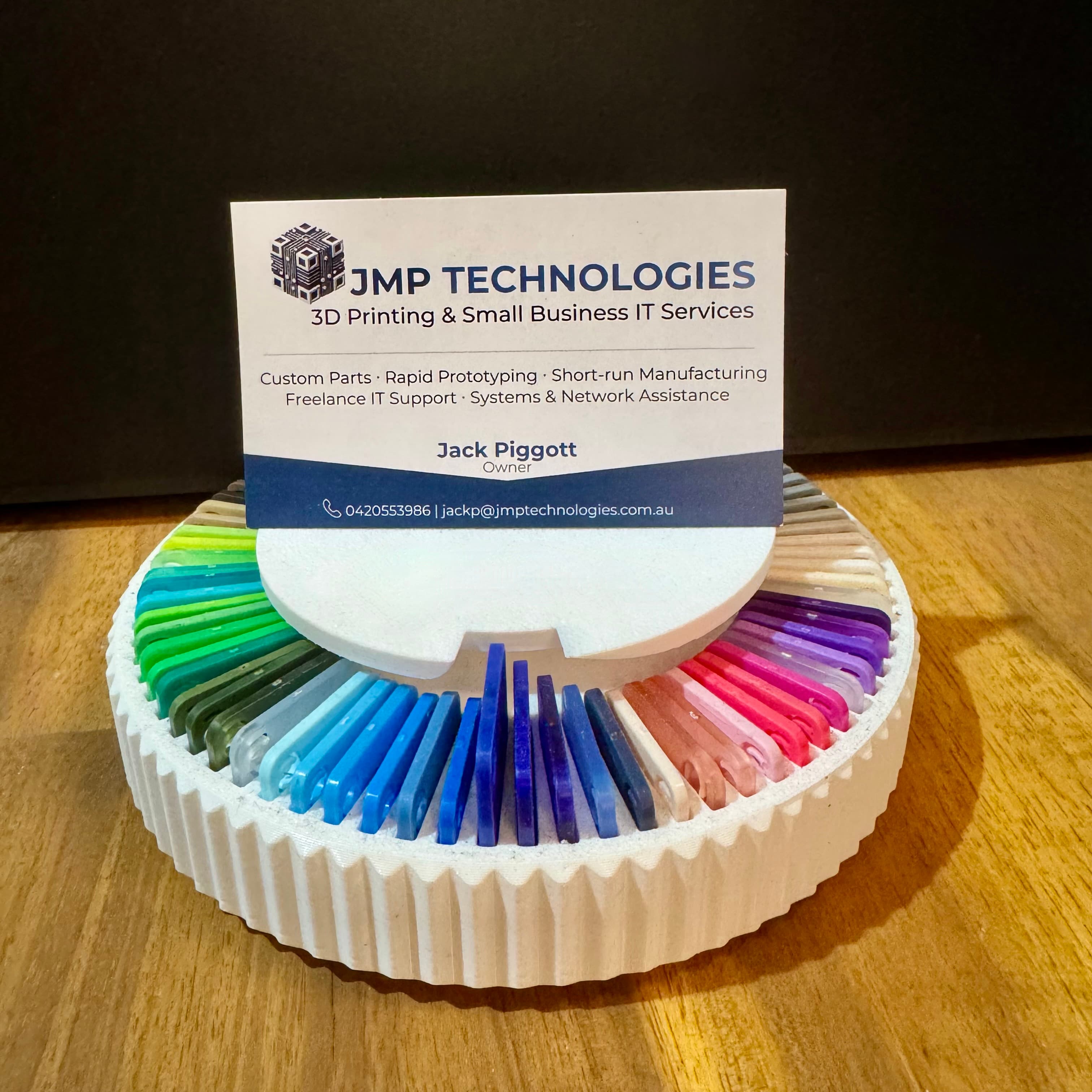 JMP Technologies business card resting on a filament colour selection wheel
